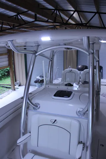  Yacht Photos Pics 2017 Jupiter 30 HFS boat interior under a metal roof, showcasing seating and console.
