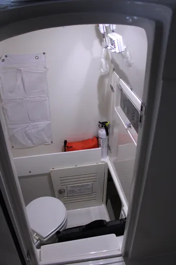  Yacht Photos Pics Interior of 2017 Jupiter 30 HFS boat bathroom with toilet and safety equipment.