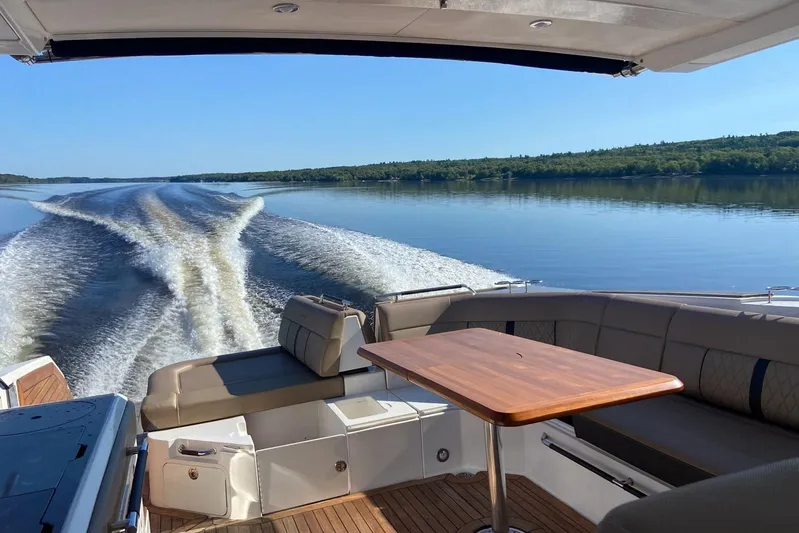  Yacht Photos Pics 2017 Sea Ray SLX 400 cruising on a serene lake with wake trails.