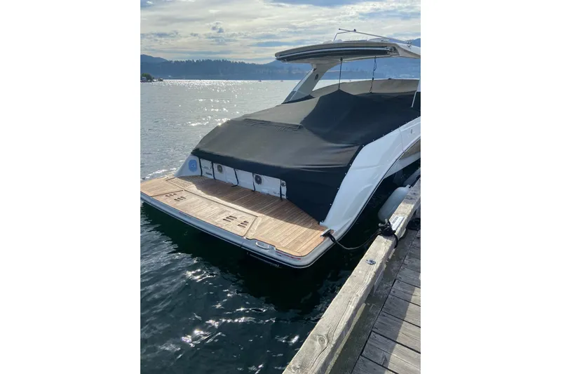  Yacht Photos Pics 2017 Sea Ray SLX 400 yacht docked, featuring a covered deck and scenic water view.