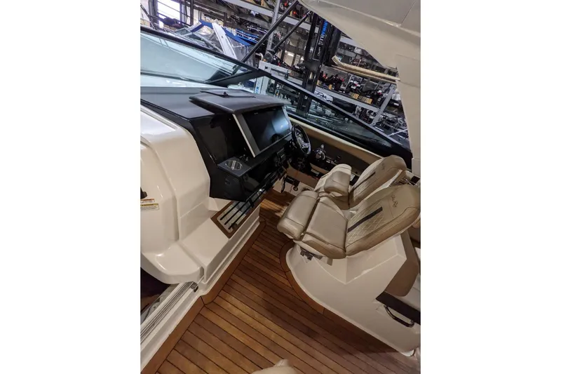  Yacht Photos Pics Interior view of 2017 Sea Ray SLX 400 boat with luxurious seating and modern dashboard.