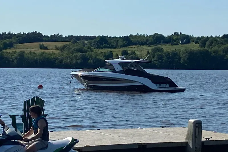  Yacht Photos Pics 2017 Sea Ray SLX 400 boat on a serene lake near a dock.