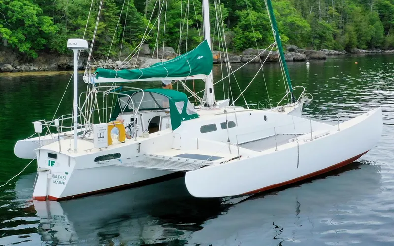 If Yacht Photos Pics 2018 Custom Marples CC 40 Fast Cruiser sailboat on calm water, green forest background.