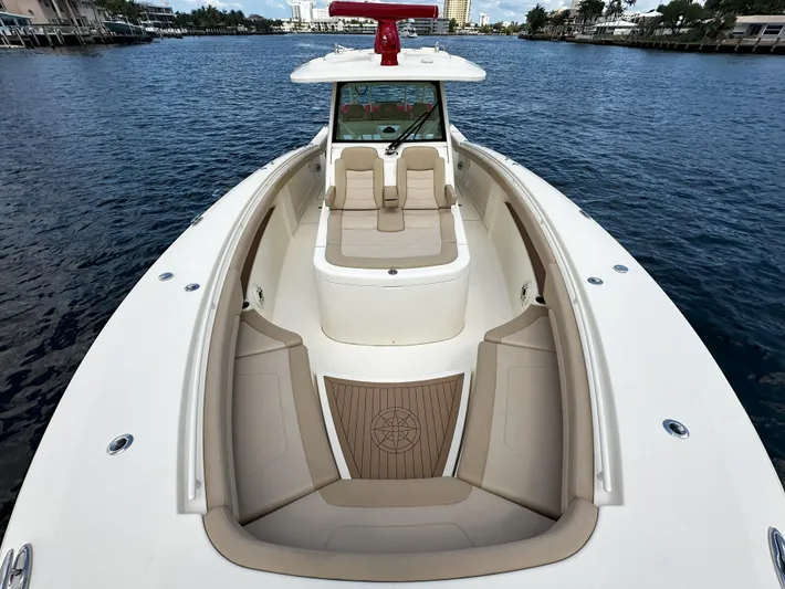  Yacht Photos Pics 2020 Scout 380 LXF boat on water, featuring spacious seating and elegant design.