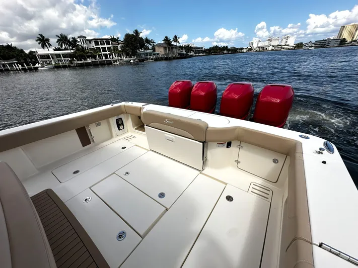  Yacht Photos Pics 2020 Scout 380 LXF boat with red engines on a scenic waterfront.