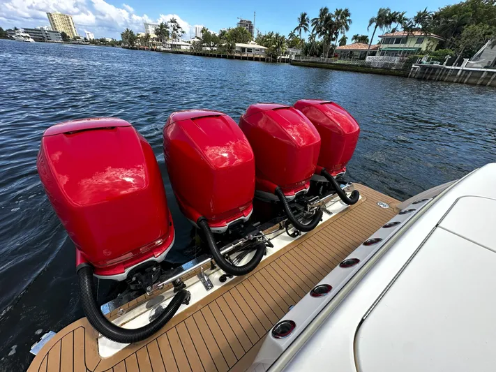  Yacht Photos Pics 2020 Scout 380 LXF boat with four red outboard engines on a sunny waterfront.