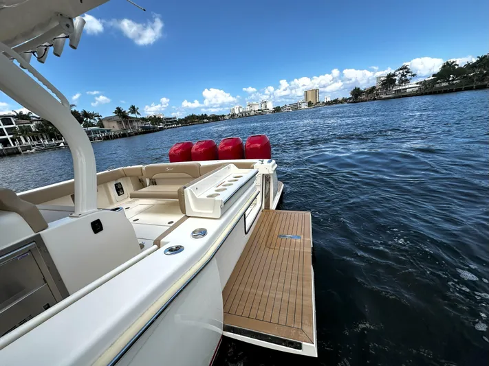  Yacht Photos Pics 2020 Scout 380 LXF boat on water, featuring spacious deck and scenic waterfront view.