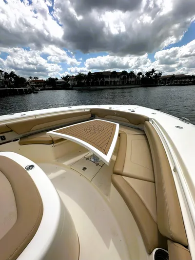  Yacht Photos Pics 2020 Scout 380 LXF boat with luxurious seating and table on a sunny day.