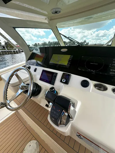  Yacht Photos Pics 2020 Scout 380 LXF boat helm with advanced navigation controls and scenic water view.