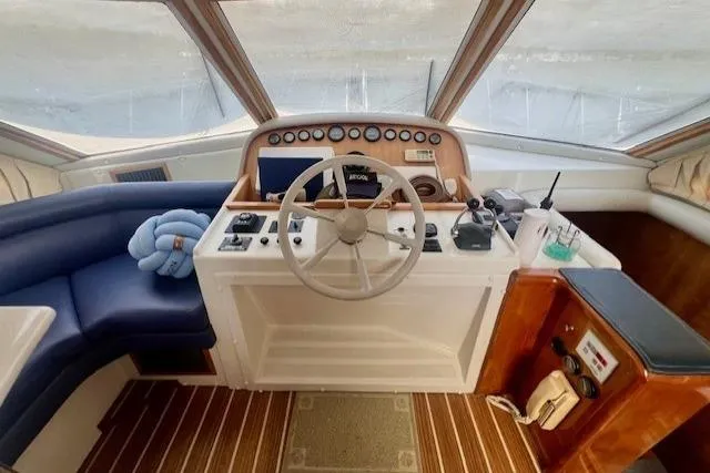  Yacht Photos Pics Helm of 2002 Navigator Classic 53 yacht with steering wheel and control panel.