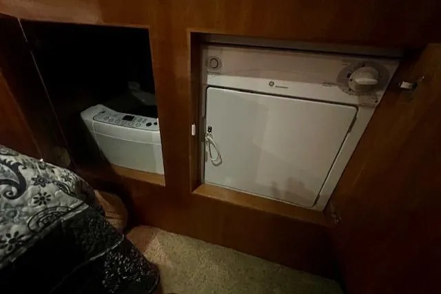  Yacht Photos Pics Laundry area inside a 2002 Navigator Classic 53 yacht, featuring a washer and dryer.