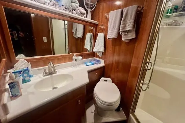  Yacht Photos Pics Luxurious bathroom in 2002 Navigator Classic 53 yacht with wood paneling and modern amenities.