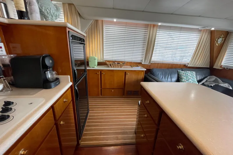  Yacht Photos Pics Luxurious 2002 Navigator Classic 53 yacht interior with kitchen and seating area.