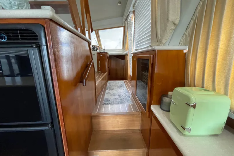  Yacht Photos Pics Interior of 2002 Navigator Classic 53 yacht with wooden cabinetry and compact green appliance.