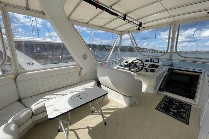  Yacht Photos Pics Interior of 2002 Navigator Classic 53 yacht with helm, seating, and nautical decor.