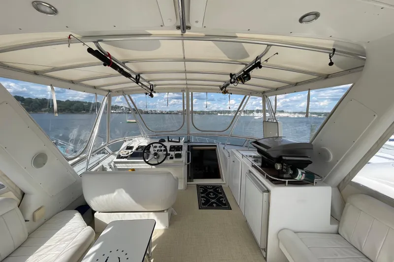  Yacht Photos Pics Interior view of 2002 Navigator Classic 53 yacht with steering wheel and seating area.