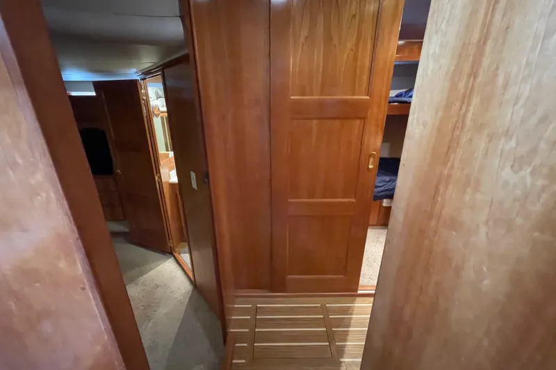  Yacht Photos Pics Interior of 2002 Navigator Classic 53 yacht with wooden paneling and cozy cabin spaces.
