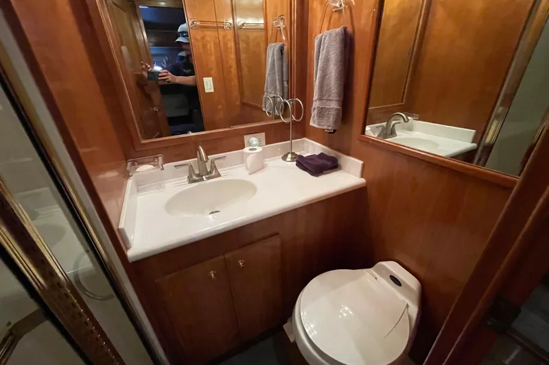  Yacht Photos Pics Luxurious bathroom in 2002 Navigator Classic 53 yacht with wood paneling and modern fixtures.