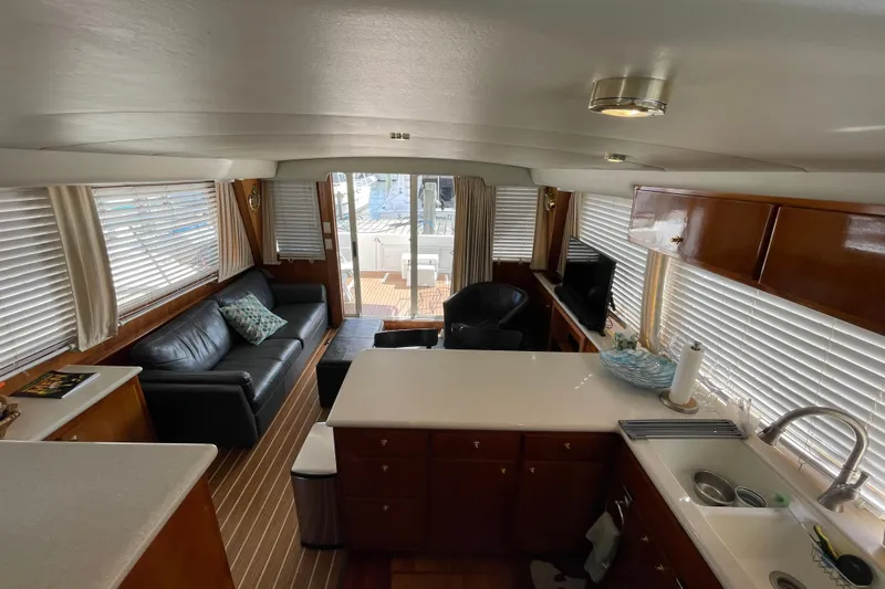  Yacht Photos Pics Luxurious interior of 2002 Navigator Classic 53 yacht with modern kitchen and cozy seating area.