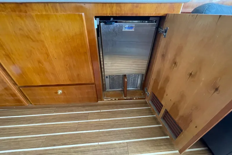  Yacht Photos Pics Wooden cabinet with open door revealing a stainless steel appliance on Navigator Classic 53 yacht.