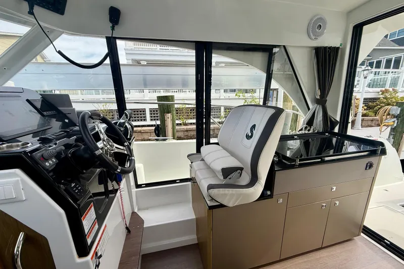  Yacht Photos Pics Interior of 2021 Beneteau Antares 9 boat, featuring helm and seating area.