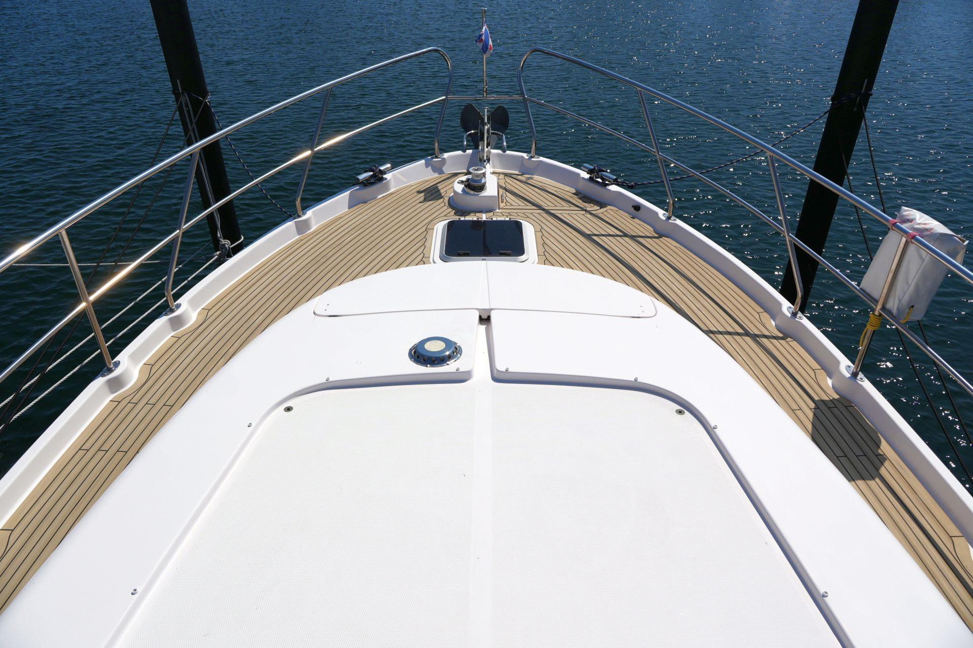 2016 Elling E3 Ultimate yacht deck with wooden finish, overlooking calm water.