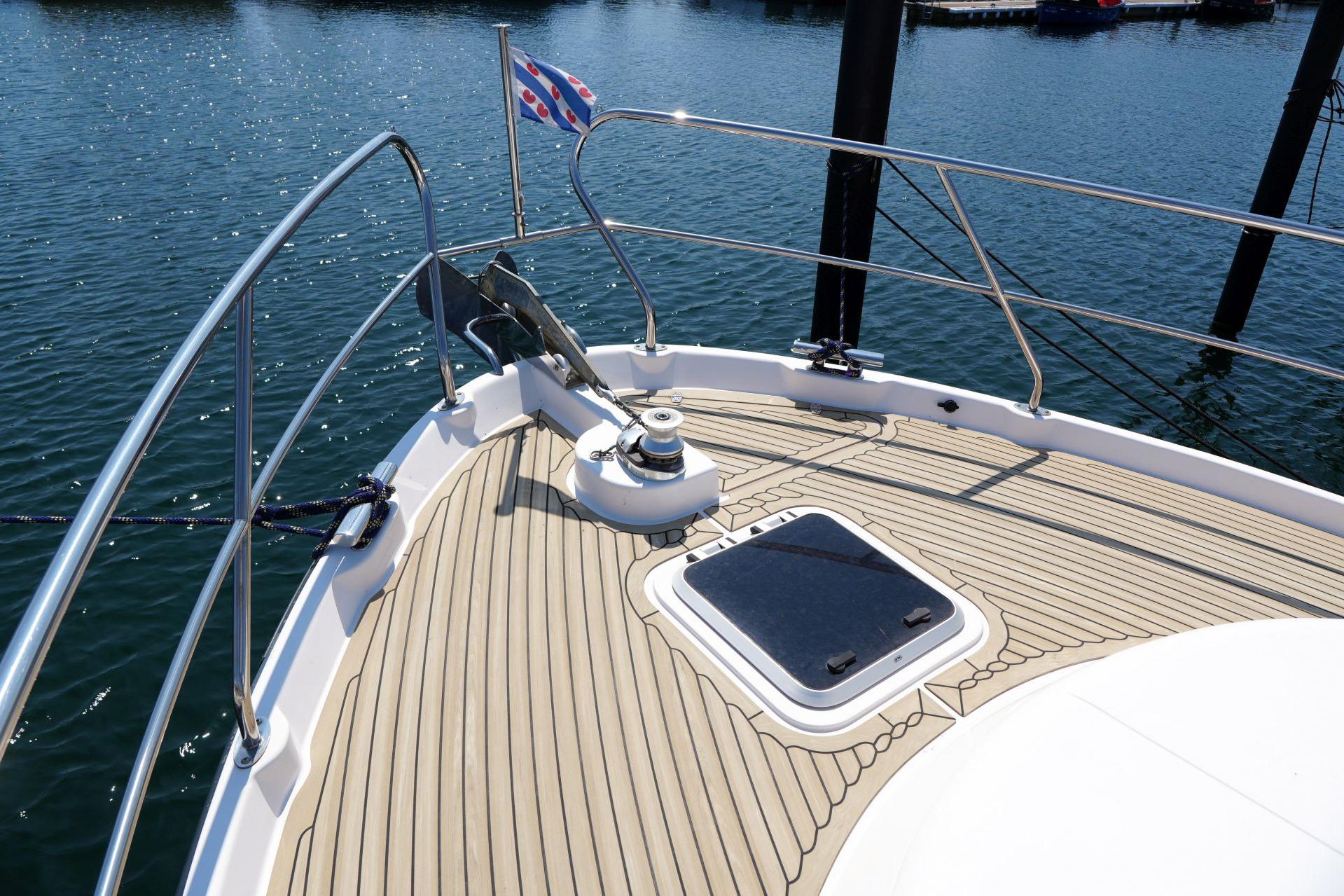 Bow of 2016 Elling E3 Ultimate yacht with wooden deck and water view.