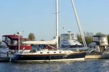 Mistral X Yacht Photos Pics 2009 Tartan 4300 sailboat docked at a marina with other boats.