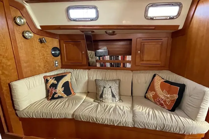 Mistral X Yacht Photos Pics Cozy Tartan 4300 yacht interior with cushioned seating and decorative pillows, 2009 model.