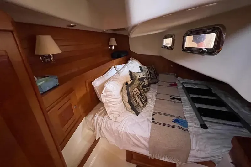 Mistral X Yacht Photos Pics Cozy cabin interior of 2009 Tartan 4300 yacht with wooden paneling and decorative pillows.