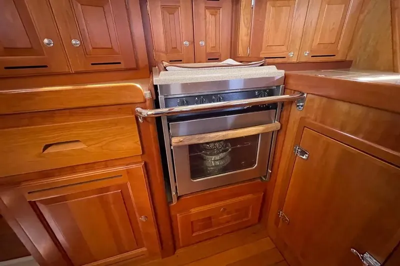 Mistral X Yacht Photos Pics Wooden kitchen interior with stainless steel oven in 2009 Tartan 4300 yacht.