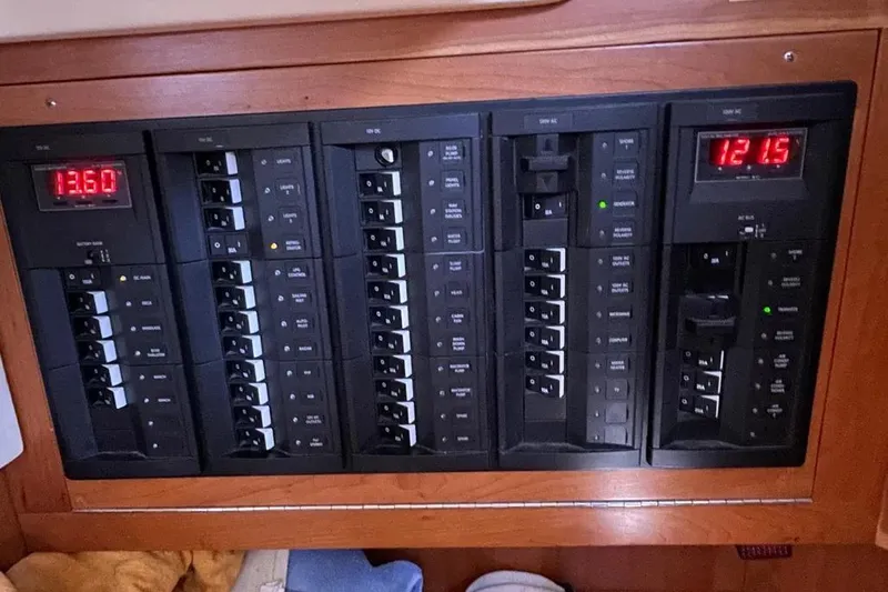 Mistral X Yacht Photos Pics Electrical control panel on a 2009 Tartan 4300 yacht, featuring multiple switches and digital displays.