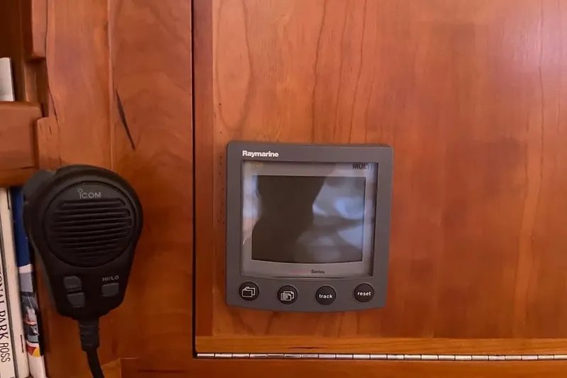 Mistral X Yacht Photos Pics Raymarine display and Icom microphone on Tartan 4300, 2009 model, wooden panel background.