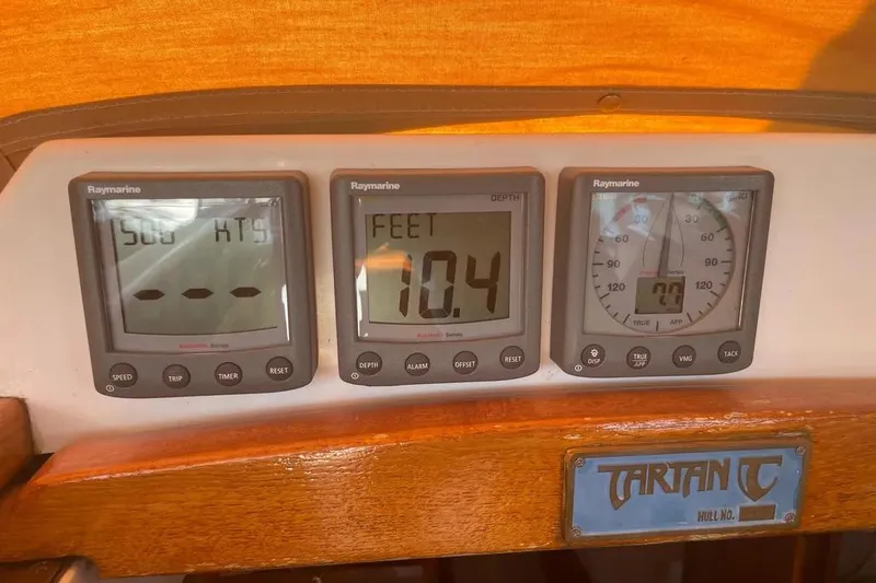 Mistral X Yacht Photos Pics Tartan 4300 yacht dashboard with Raymarine instruments, displaying speed, depth, and wind data.