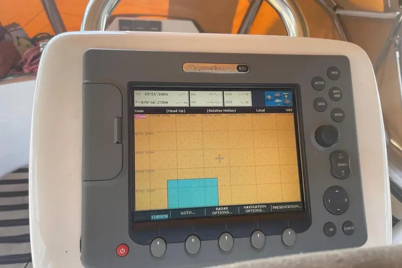 Mistral X Yacht Photos Pics Navigation system on a 2009 Tartan 4300 sailboat displaying coordinates and map.