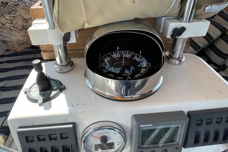 Mistral X Yacht Photos Pics Boat cockpit with compass, controls, and gauges on a 2009 Tartan 4300.