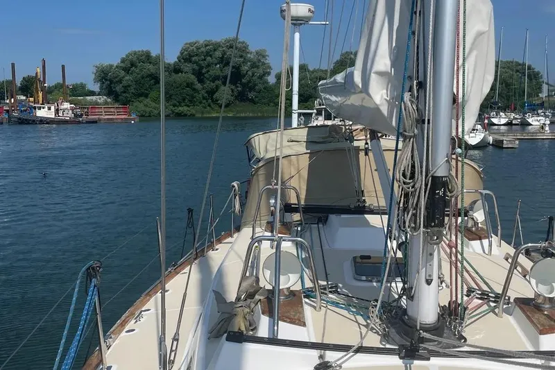 Mistral X Yacht Photos Pics Sailboat Tartan 4300, 2009 model, docked in a serene marina setting.