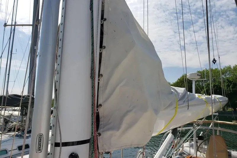 Mistral X Yacht Photos Pics Sailboat mast and sail of 2009 Tartan 4300 in marina setting.