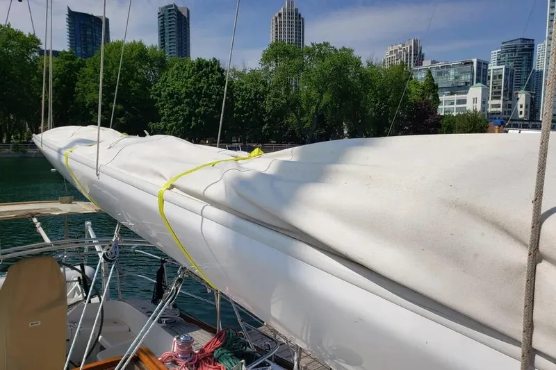 Mistral X Yacht Photos Pics Sailboat Tartan 4300 (2009) docked with covered sails, city skyline in background.