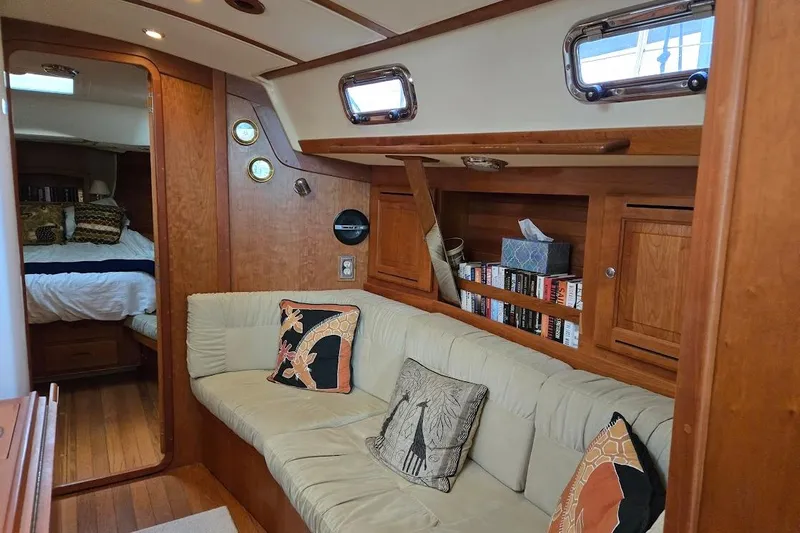 Mistral X Yacht Photos Pics Cozy interior of 2009 Tartan 4300 yacht with plush seating and wooden accents.