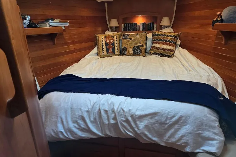 Mistral X Yacht Photos Pics Cozy cabin bedroom in 2009 Tartan 4300 yacht with wooden walls and decorative pillows.