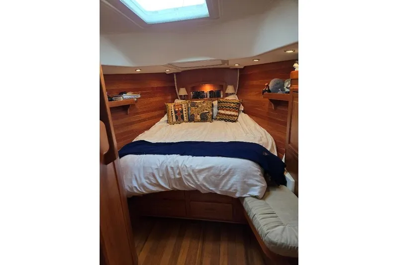 Mistral X Yacht Photos Pics Cozy cabin interior of 2009 Tartan 4300 yacht with wooden paneling and plush bedding.