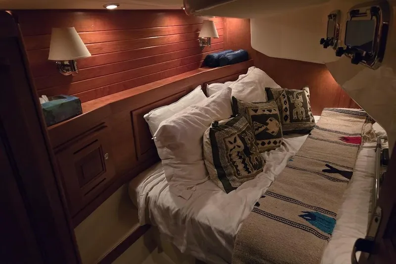 Mistral X Yacht Photos Pics Cozy cabin interior of 2009 Tartan 4300 yacht with decorative pillows and warm lighting.