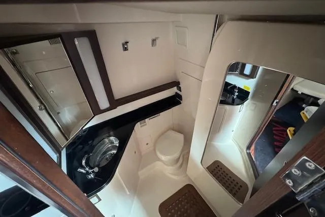  Yacht Photos Pics 2024 Grady-White Canyon 456 boat interior bathroom with sink, toilet, and mirror.