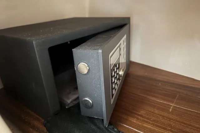  Yacht Photos Pics Open electronic safe on wooden shelf, showcasing security features.