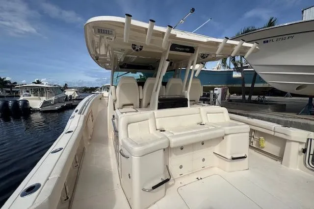  Yacht Photos Pics 2024 Grady-White Canyon 456 boat with spacious seating and modern design docked by the water.
