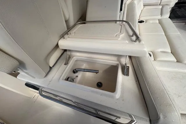  Yacht Photos Pics 2024 Grady-White Canyon 456 boat interior with built-in sink and seating area.