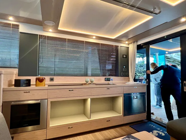  Yacht Photos Pics Modern interior of 2025 Beneteau Swift Trawler 54 with sleek kitchen design.