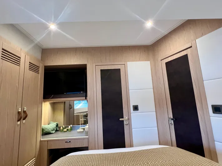  Yacht Photos Pics Interior cabin of 2025 Beneteau Swift Trawler 54 with modern wood finishes.