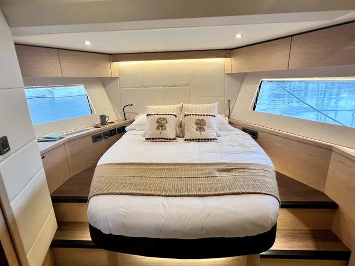  Yacht Photos Pics Luxurious bedroom in 2025 Beneteau Swift Trawler 54 with panoramic windows.